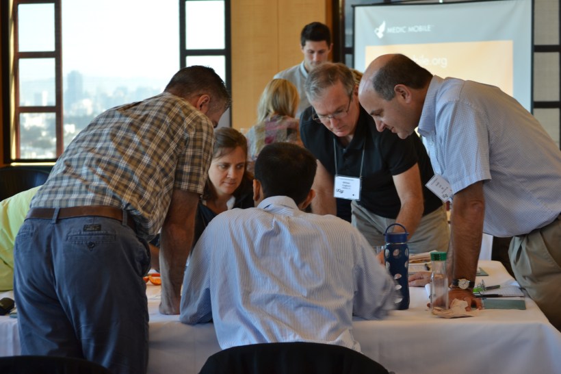 Participants work together to map a health system during Josh Nesbit's presentation on Mobile Technology.